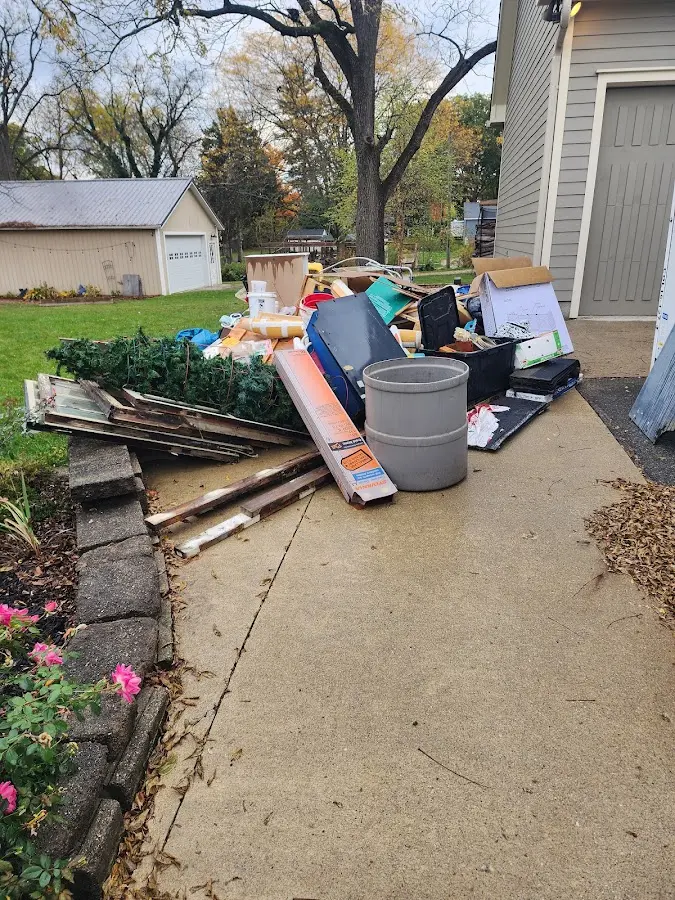 Dumpster being loaded with debris for Demolition Dumpster Rental in Mundy
